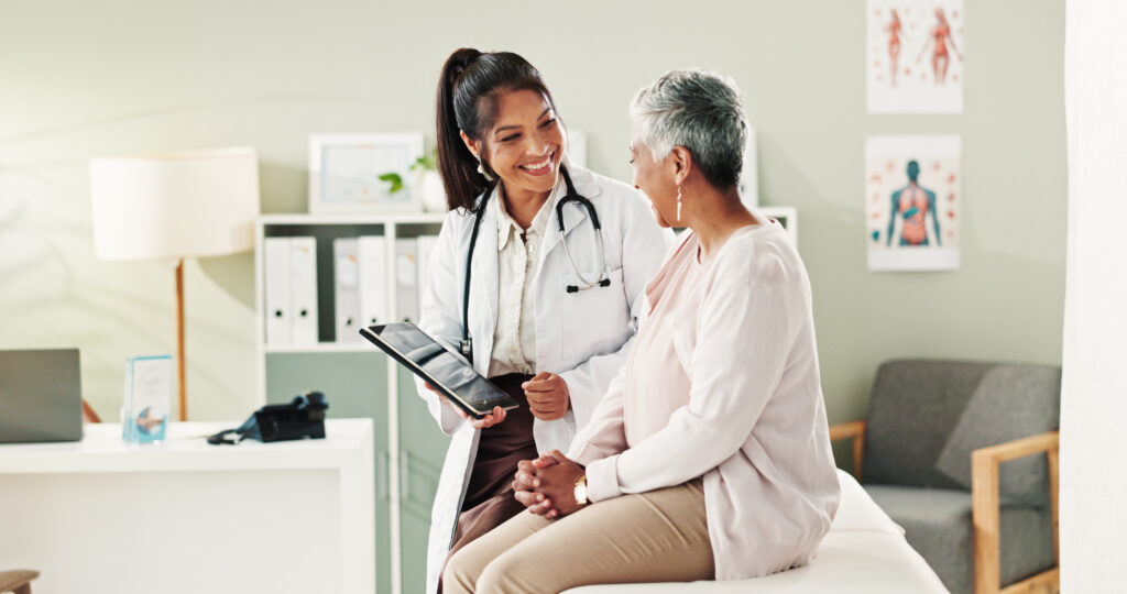 Mature woman, doctor and tablet for healthcare, support or conversation with checkup appointment in office