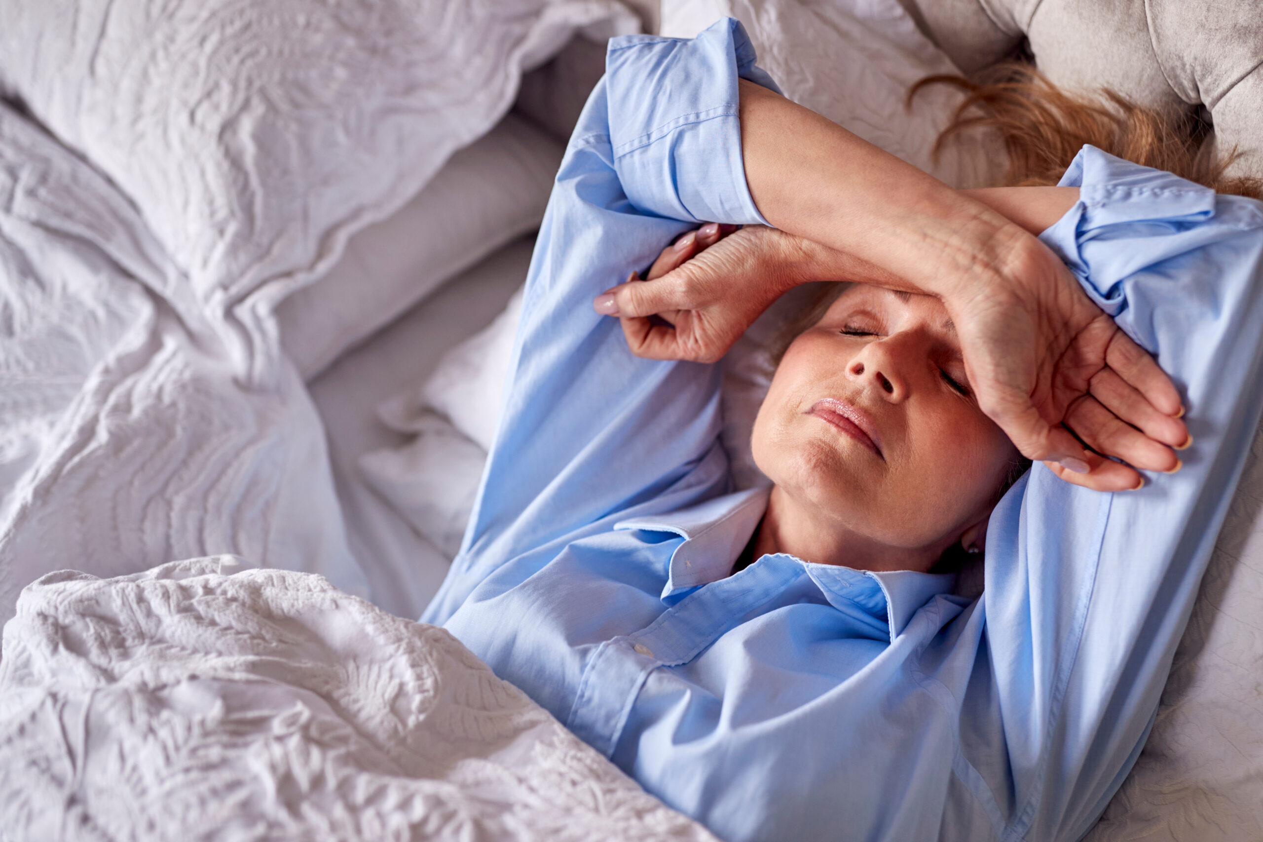 Mature Woman Suffering With Insomnia In Bed At Home